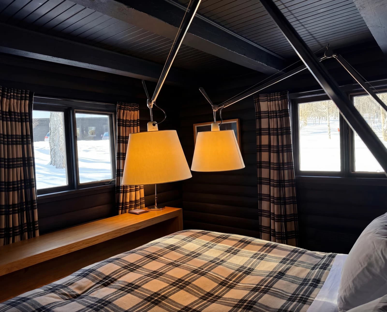 Bedroom with plaid bedding under the dormer